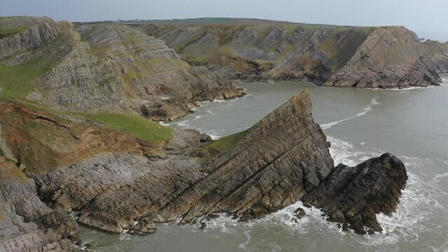 Aerial of The Knave along the dramatic coast of the Gower Peninsula, Wales, United Kingdom, Europe