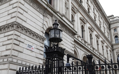A low angle view of the entrance to Downing Street, Westminster, London, UK. 
