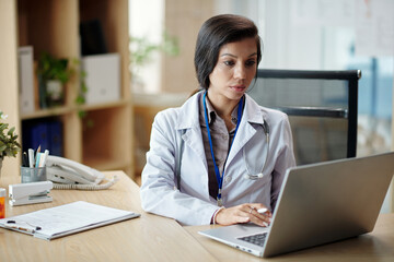 Manager of clininc answering e-mails from clients