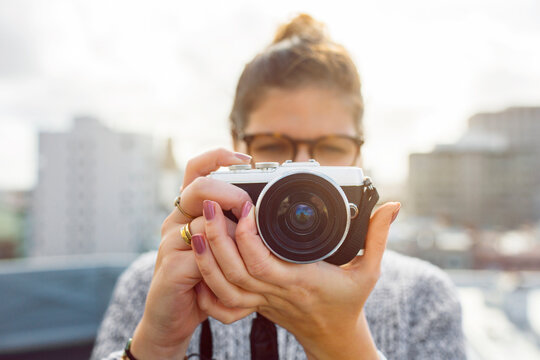 Young woman holding camera