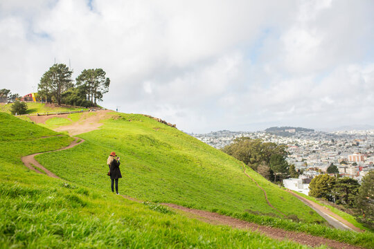 Woman standing on green hill