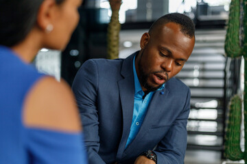 Businessman listening and looking at partner in meeting