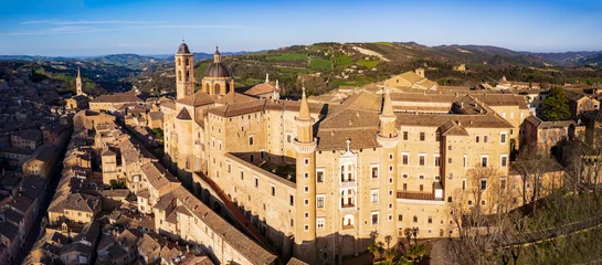 Fotobehang One of the most beautiful medieval towns of Italy - Urbino in Marche region. aerial drone panoramic high angle view over sunset © Freesurf