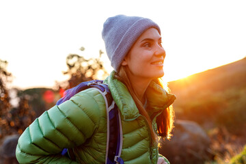 Portrait of smiling female caucasian hiker in winter clothes