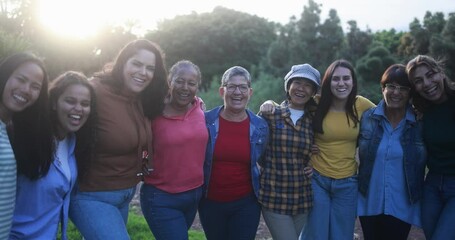 Multi generational women smiling in front of camera - Female multiracial group having fun together outdoor - Powered by Adobe
