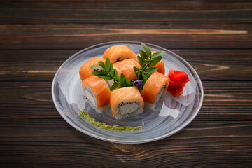 Exquisite sushi rolls with traditional accompaniments, with wasabi and ginger
