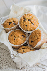 Peanutbutter and chocolate chips muffins homemade on white background close up selective focus