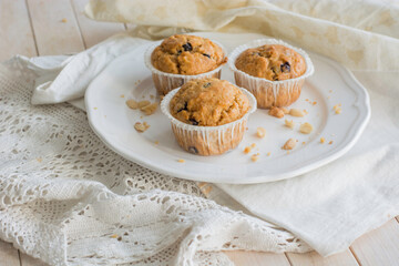Peanutbutter and chocolate chips muffins homemade on white background close up selective focus