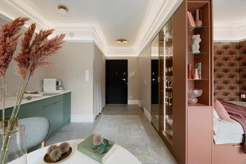 Interior design of open space corridor interior with black door, gray rug, pink and green shelf,...