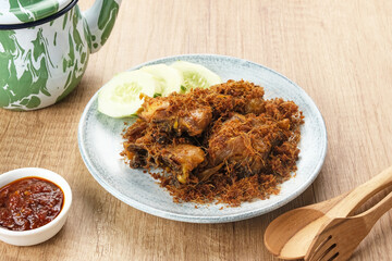Ayam Goreng Lengkuas, fried chicken cooked with spices and sprinkled with grated galangal. Indonesian traditional food.  
