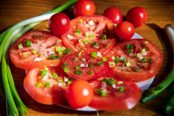 Fototapeta na wymiar Tomato salad with onion on the wooden table...
