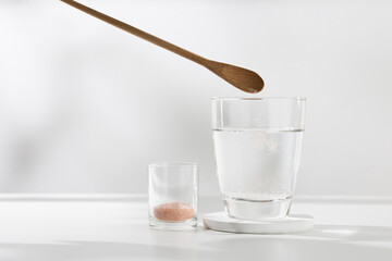 Fototapeta na wymiar Mix pink himalayan mineral salt to your drinking water for health.