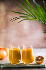 Two mango lassi or kesar milk in glasses. Indian healthy ayurvedic cold drink with mango. Freshness...