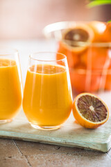 Two mango lassi or kesar milk in glasses. Indian healthy ayurvedic cold drink with mango. Freshness lassi made of yogurt, water, spices, fruits and ice.