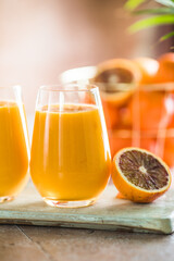 Two mango lassi or kesar milk in glasses. Indian healthy ayurvedic cold drink with mango. Freshness lassi made of yogurt, water, spices, fruits and ice.