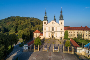 Fototapeta na wymiar Poland. Kalwaria Zebrzydowska. Catholic church and monastery with great famous Calvary in the surrounded woodland. UNESCO World Heritage Site. Popular pilgrimage destination. Aerial view in summer