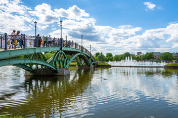 Naklejka premium Tsaritsynsky park in Moscow on a sunny summer day. View of the river with reflection and bridge. Tsaritsynsky Park is one of the main tourist attractions in Moscow.