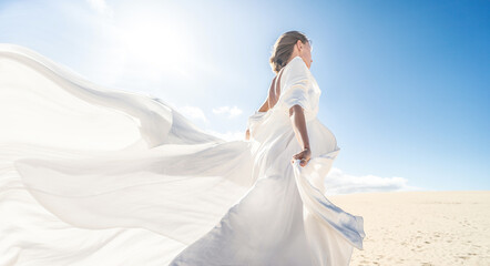 Photo of a woman in amazing white wedding dress posing on the desert, sunny light, blue sky,