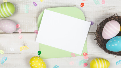 Art Happy Easter concept. Frame of Easter eggs, letter, greeting card and on white wooden background. Flat lay, top view, copy space.