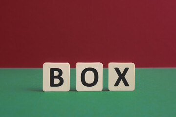 Word BOX written with leisure game tiles. Conceptual image representing a testual message communicated using letters from a board game.