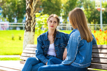 Two young female students met in a summer park