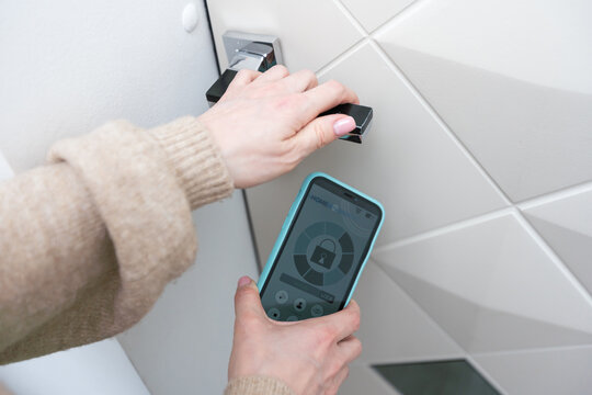 Hotel door security Unlocking by application on mobile phone. Digital door lock, key less system of access door. Close up