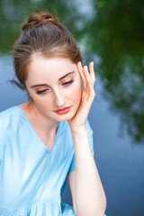 Young beautiful woman in turquoise dress