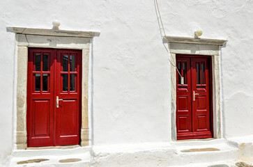 Red door, typical of a house on the island of Myconos, Cyclades, Greece	