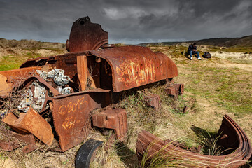 Tank Sherman M4 wreckage from WW2 in sand dunes of Normandy