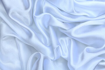 Satin beautiful fabric of gray color lies with drapery.