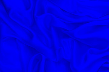 Satin beautiful blue silk fabric lies with drapery.	