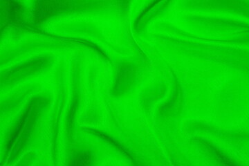 Satin beautiful green silk fabric lies with drapery.