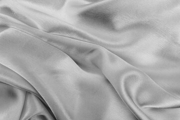 Naklejka na ściany i meble Satin beautiful fabric of gray color lies with drapery.