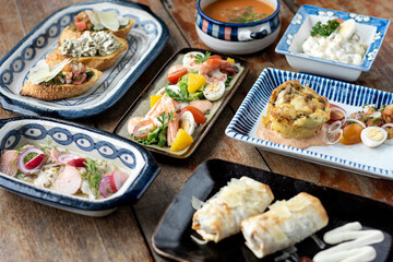 selection of many different tapas on rustic wood table