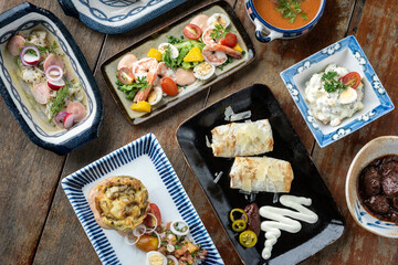 selection of many different tapas on rustic wood table