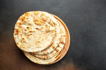 pita bread on a wooden board. Traditional Arabic cuisine. banner, menu, recipe place for text, top...