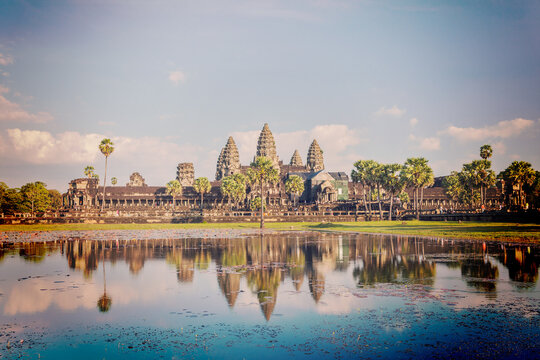 Vintage retro effect filtered hipster style image of Cambodia landmark Angkor Wat with reflection in water