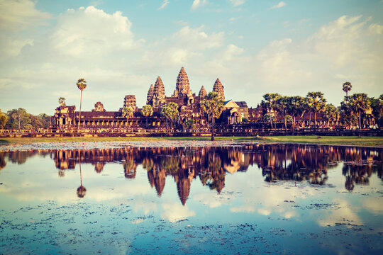 Vintage retro effect filtered hipster style travel image of Cambodia landmark Angkor Wat with reflection in water