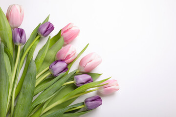Obraz premium Beautiful tulips on light background, flat lay. Space for text