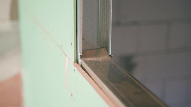 The frame from the U profile is sheathed with drywall close-up. Frame partition made of moisture-resistant drywall