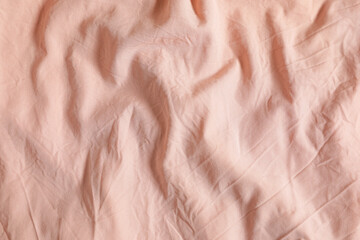 Crumpled pink fabric as background, top view