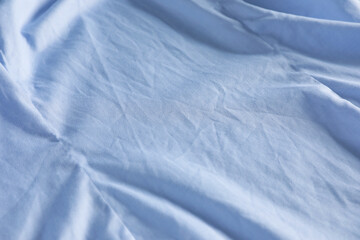 Crumpled light blue fabric as background, closeup view