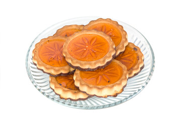 Biscuit cookies with orange jelly on glass plate