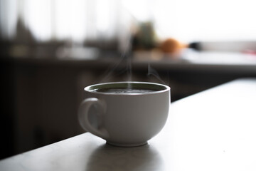 cup of hot drink on the table with aromatic steam