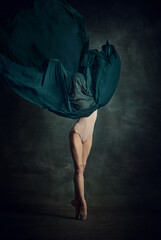 Young girl dancing with elegance movements and fabric cover the face over dark green background © Lustre Art Group 