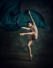 One emotional ballerina dancing with fabric on fingertips over dark green background © Lustre Art Group 