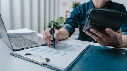 Business bookkeeping with calculator of bookkeeper and household calculating chart graph annual financial account.