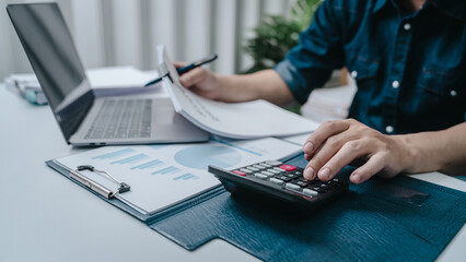 Business bookkeeping with calculator of bookkeeper and household calculating chart graph annual financial account.
