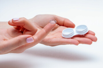 Lens eye. Contact Eye Lens. Closeup Of Woman Hands Holding White Eyelense Container. Beautiful...