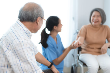 Asian nurse support senior elderly male, Asian older aged man doing physiotherapist in home living room using walker workout exercise for patient with caregiver in health insurance nursing care